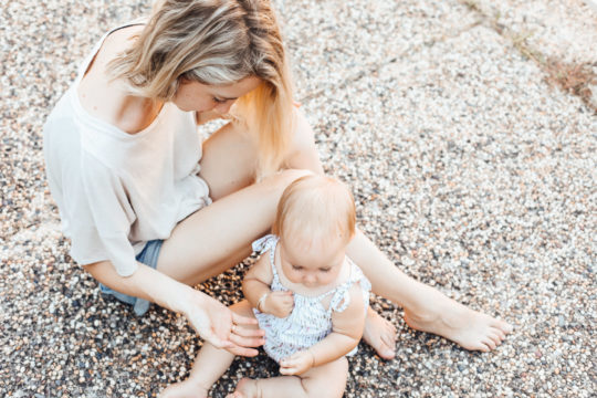 Photo d'une mère assise par terre avec son bébé